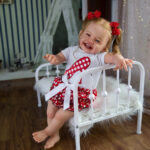 Reborn Baby dolls. a smiling happy reborn doll girl.